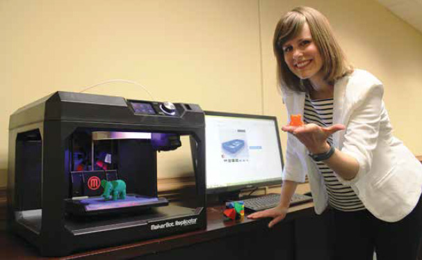 Cobb County Virtual Librarian Shannon Tyner showing off a 3D printed frog.